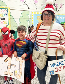Woman next to two students dressed up for Halloween