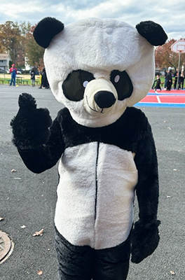 School representative dressed up in a panda suit for Halloween