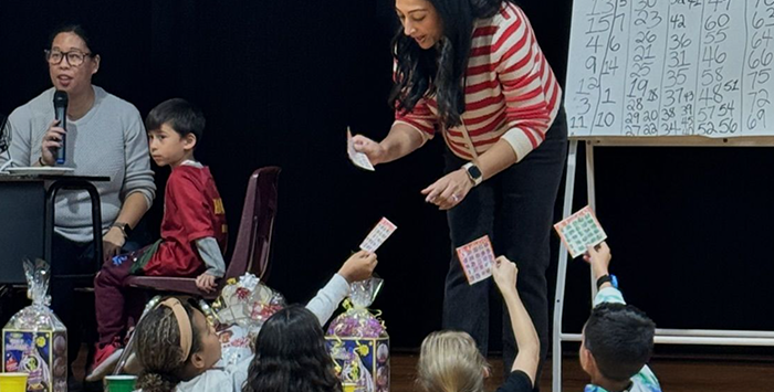 Teacher handing out bingo cards to students