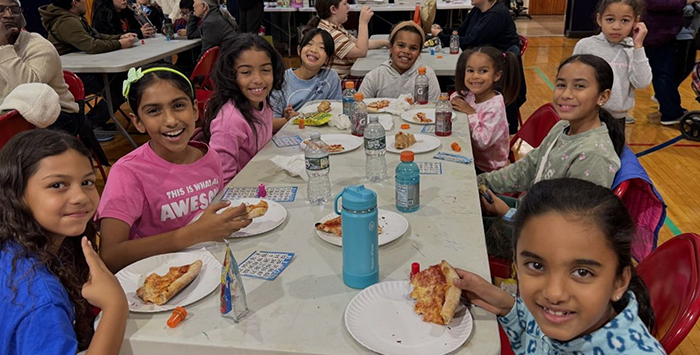 Students smiling from a bingo table