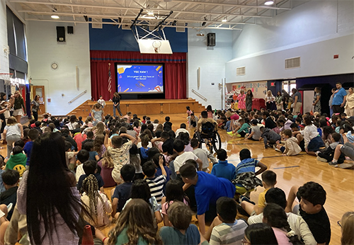 Students attending assembly in the gym