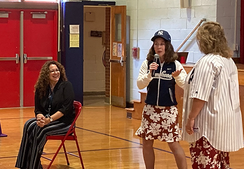 Teachers presenting during the school assembly