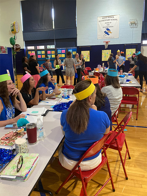 Group of teachers in paper hats