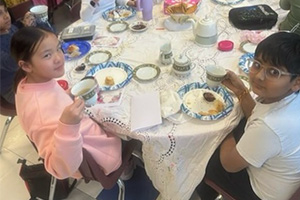 students showing their teacups