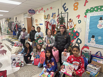 Students in the hall with toys for the toy drive